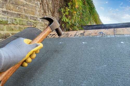 applying new felt to shed roof